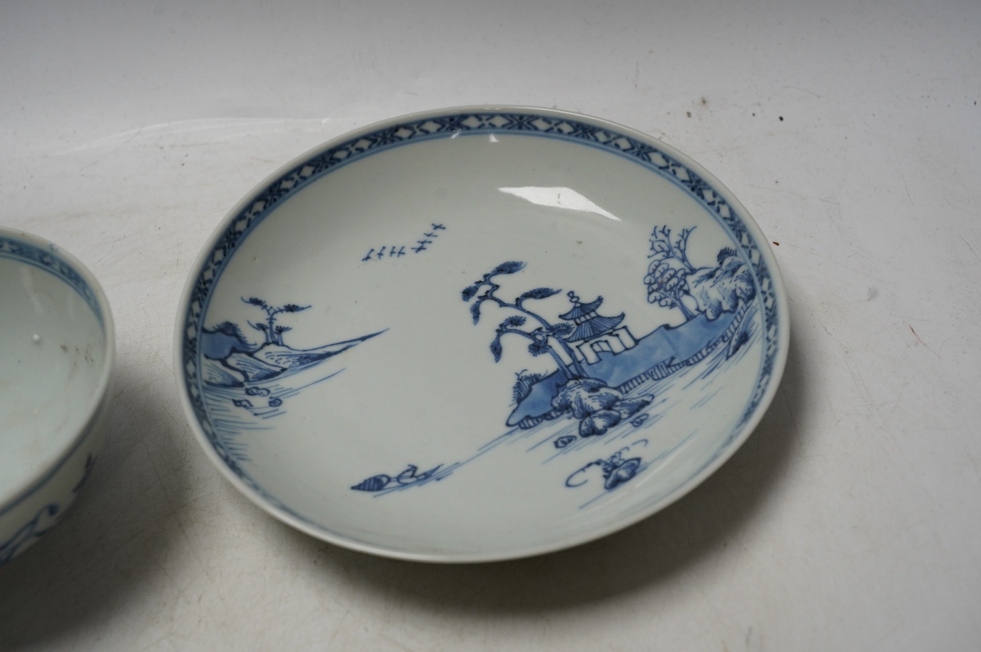 A large Chinese Nanking cargo blue and white tea bowl and saucer, saucer 17.5cm. Condition - good